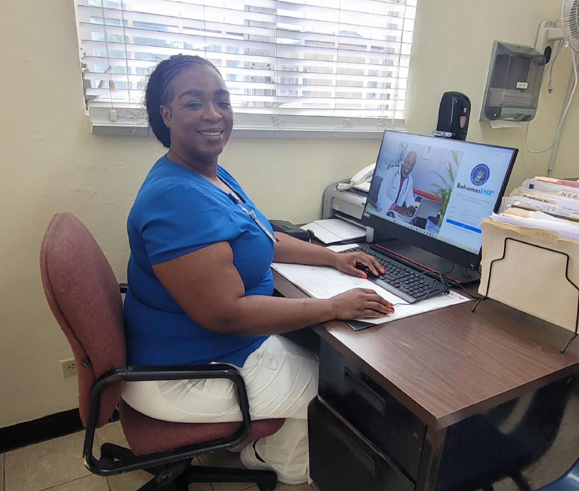 Nurse Brinique Jacques working at a computer running BahamasEMR+ at Gambier Clinic